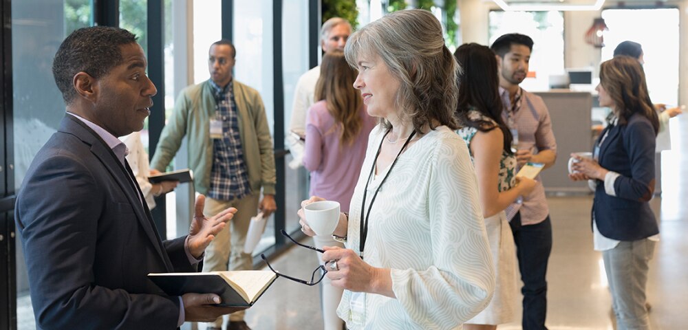 Professionals of various ages and ethnicities networking