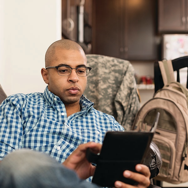 Military reservist looking at tablet