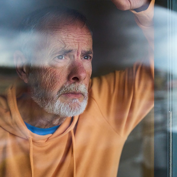 Man looking out window