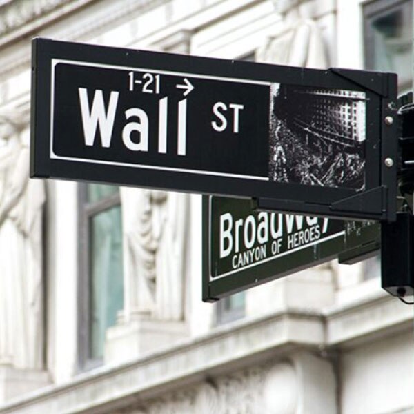 The street signs at the intersection of Wall Street and Broadway