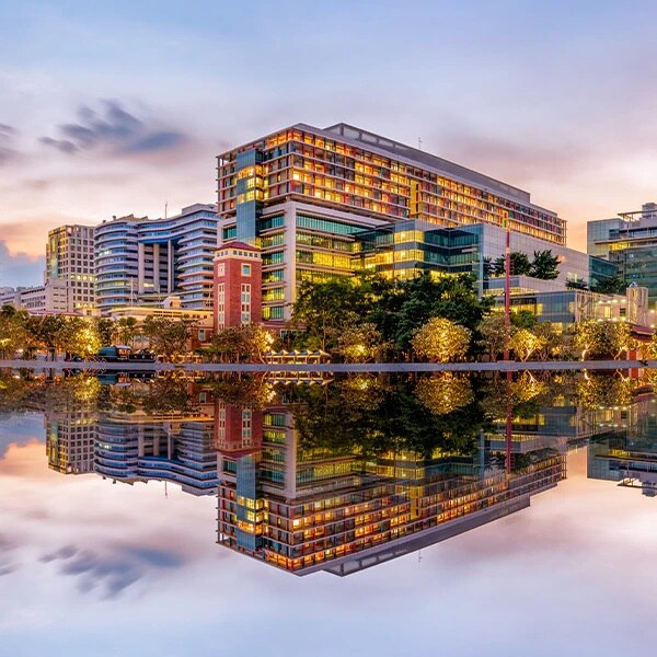 Hospital reflected in body of water
