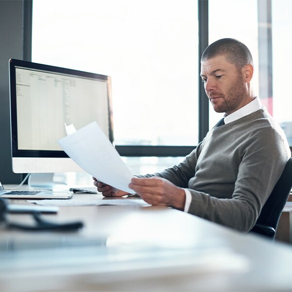 Man reading documents at desk