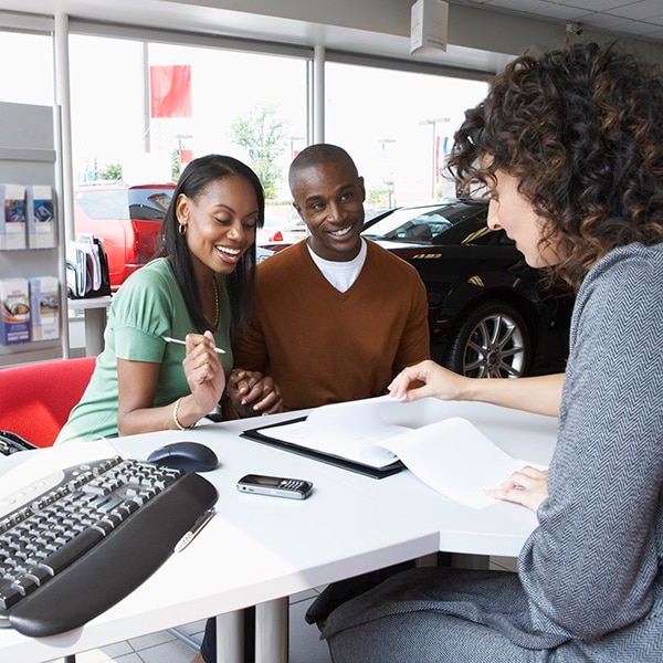 Woman and man looking at a car