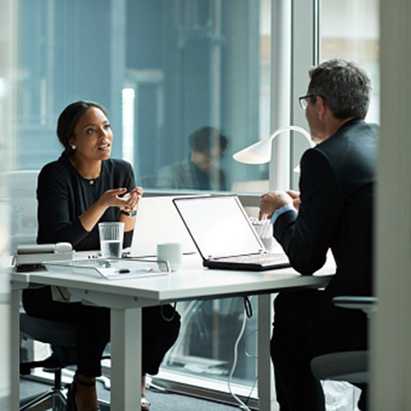Man and woman in office setting having a discussion