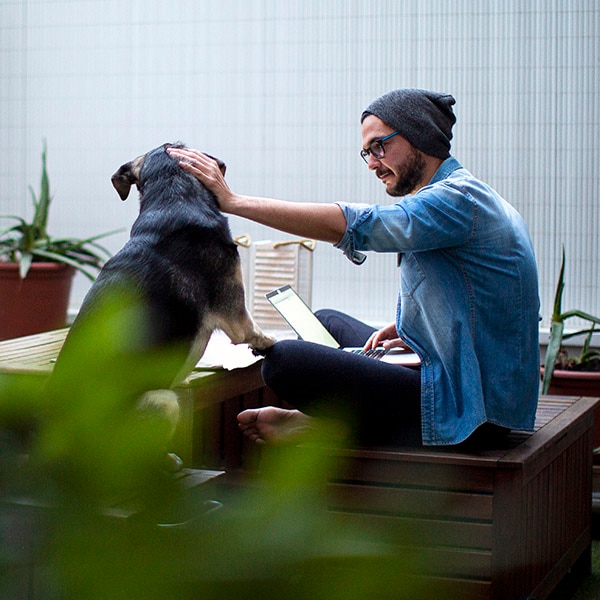 Man and dog on deck enjoying outdoors