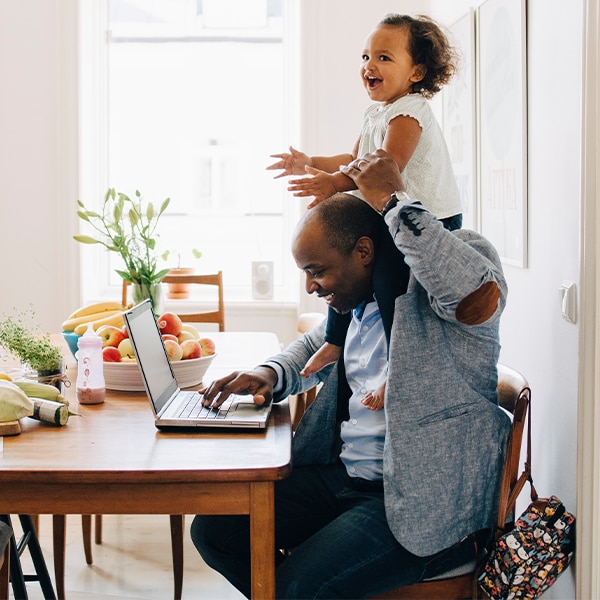 Father and child using laptop