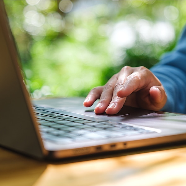 hand on top of laptop keyboard