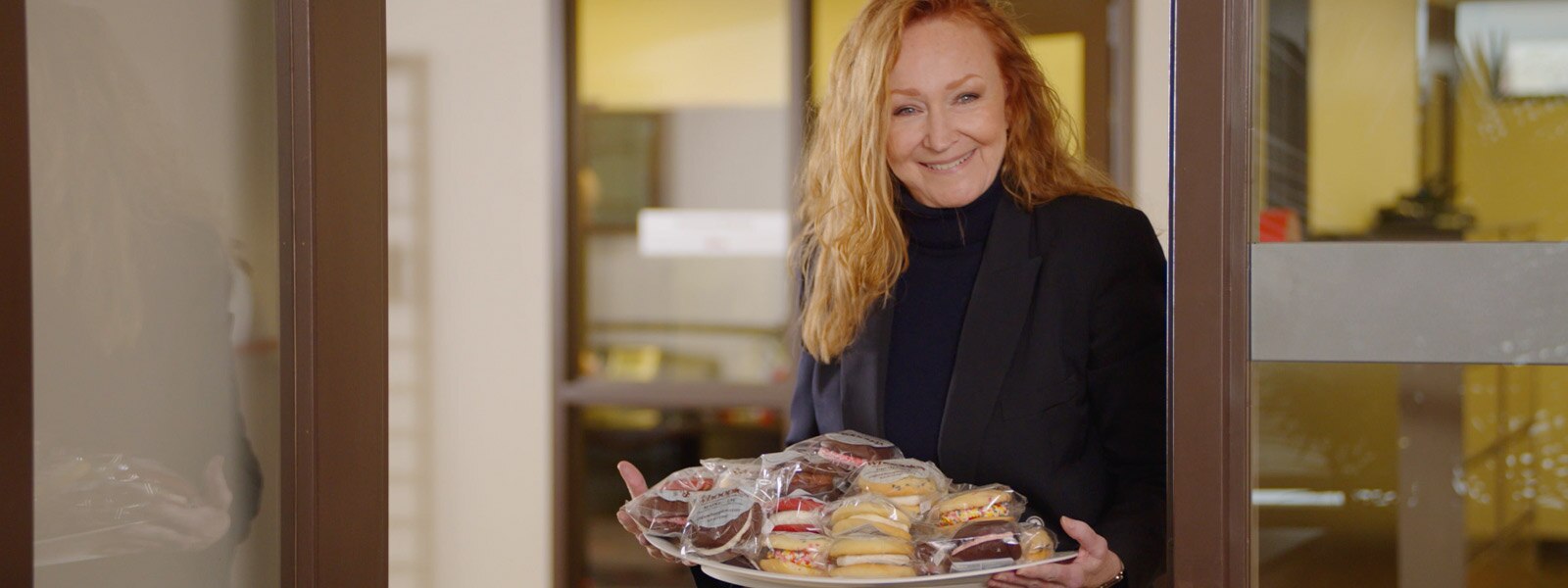 Marcia holding a platter of treats
