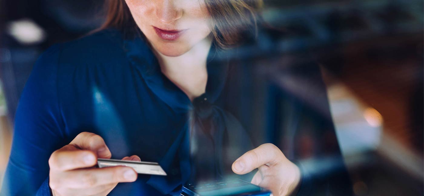 woman looking at credit card