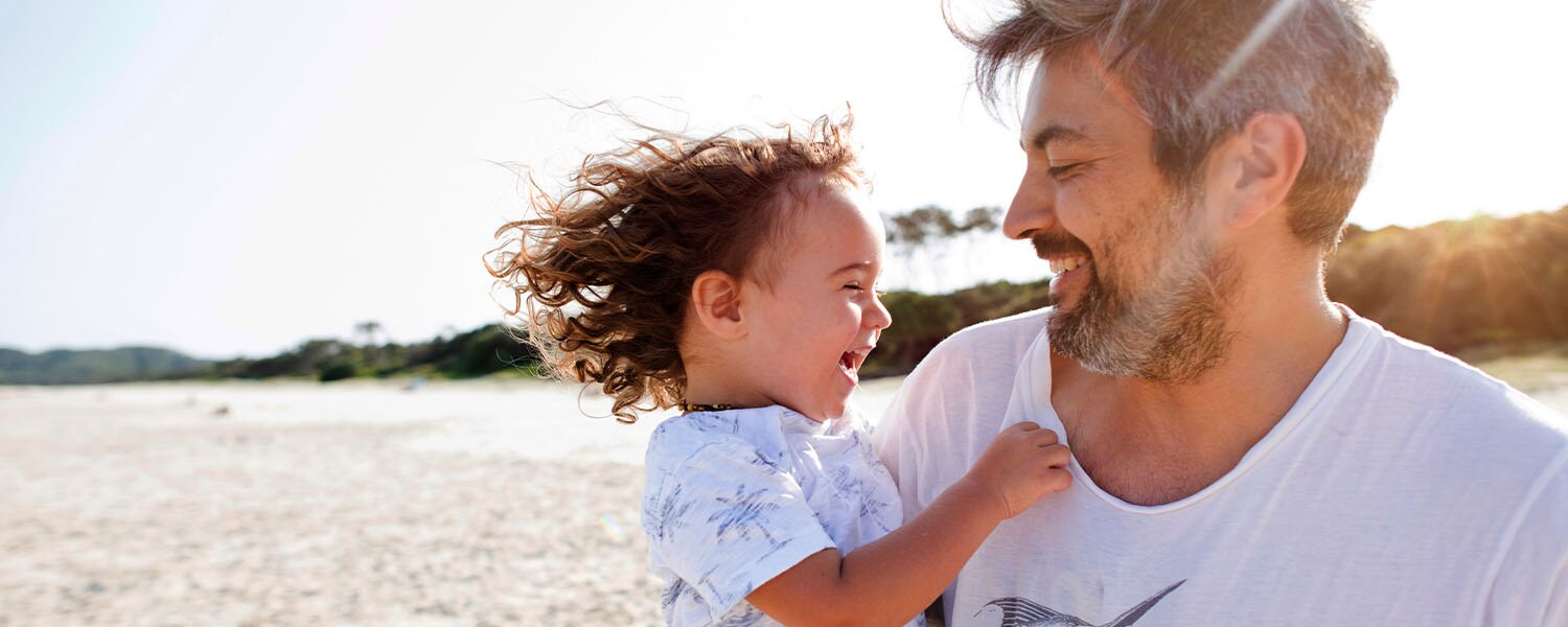 Father and child on beach