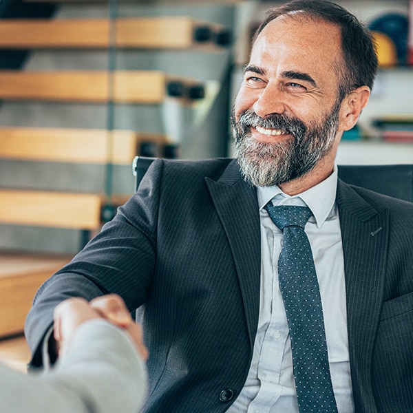 man with beard shaking hand