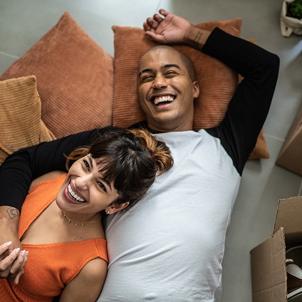 man and woman lying on pillows