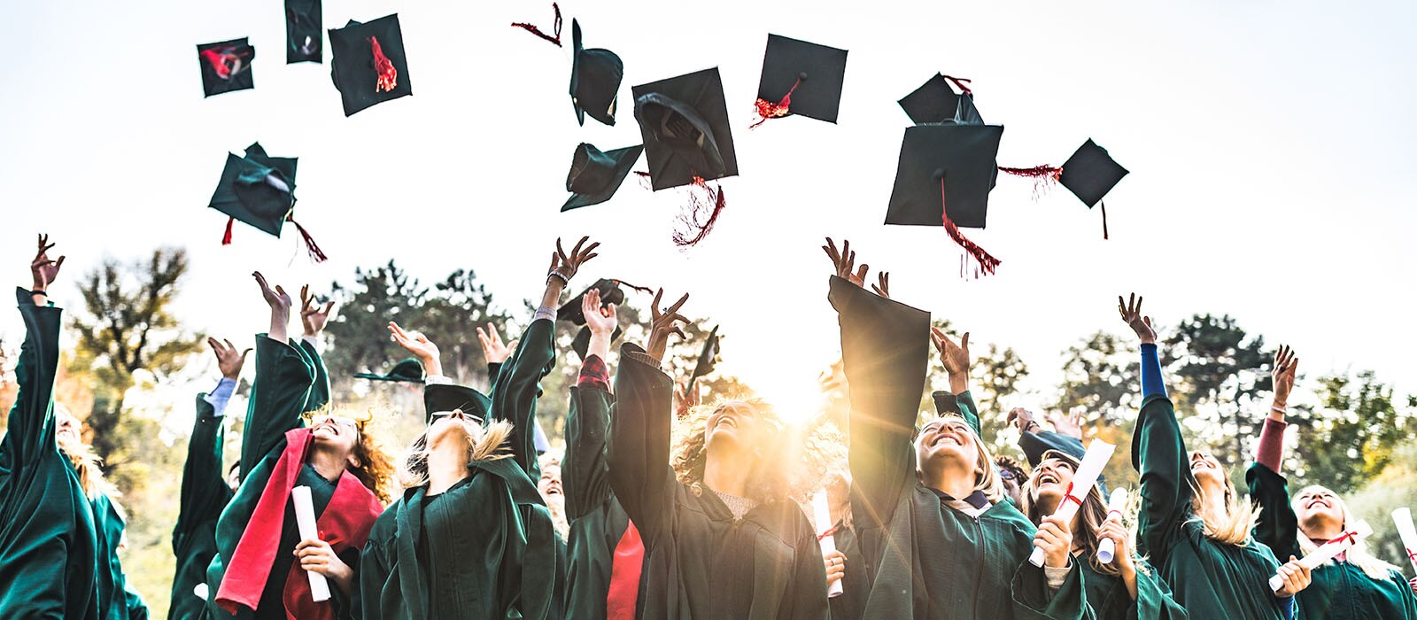 graduates tossing caps in air