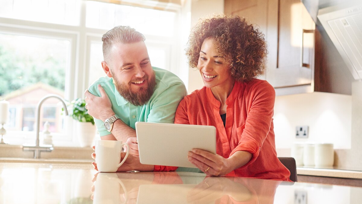 man and woman looking at a tablet