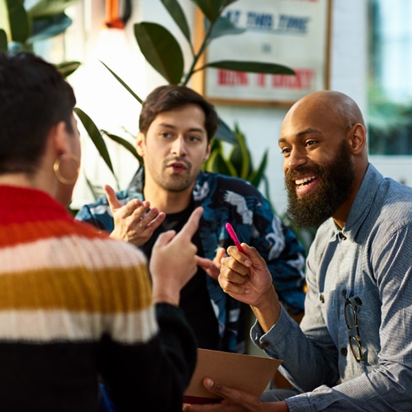Three people meeting and having a discussion.