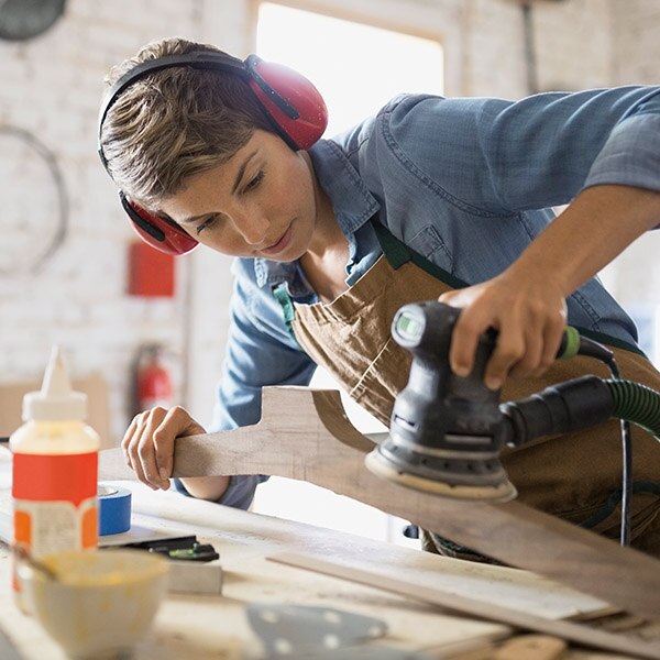 Woman using a sander