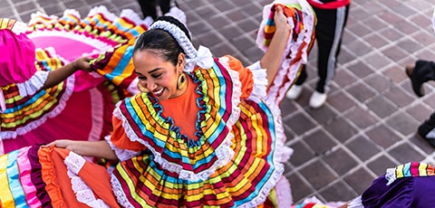 Adult woman dancing in traditional festival at public park