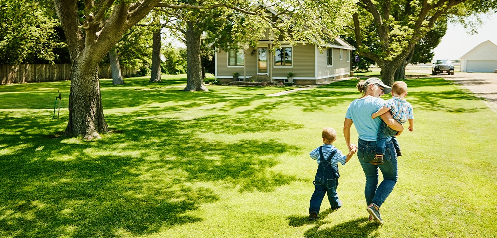Mother walking with children on sunny day